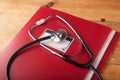 The doctor`s Desk, the stethoscope on the red folder,