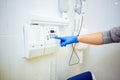 doctor`s hand in blue gloves presses the buttons on the dental scanner in the medical office