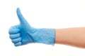 Doctor's hand in blue surgical glove showing thumbs up sign Royalty Free Stock Photo