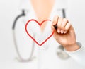 Doctor's hand drawing a heart symbol. Royalty Free Stock Photo