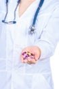 Doctor's hand holding many yellow tablets Royalty Free Stock Photo