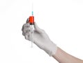 Doctor's hand holding a syringe, white gloved hand, a large syringe, the doctor makes an injection, white background Royalty Free Stock Photo