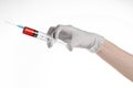 Doctor's hand holding a syringe, white gloved hand, a large syringe, the doctor makes an injection, white background Royalty Free Stock Photo