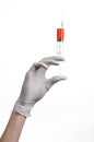 Doctor's hand holding a syringe, white gloved hand, a large syringe, the doctor makes an injection, white background Royalty Free Stock Photo