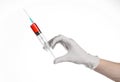 Doctor's hand holding a syringe, white gloved hand, a large syringe, the doctor makes an injection, white background Royalty Free Stock Photo