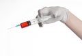 Doctor's hand holding a syringe, white gloved hand, a large syringe, the doctor makes an injection, white background Royalty Free Stock Photo