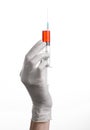 Doctor's hand holding a syringe, white gloved hand, a large syringe, the doctor makes an injection, white background Royalty Free Stock Photo