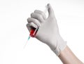 Doctor's hand holding a syringe, white gloved hand, a large syringe, the doctor makes an injection, white background Royalty Free Stock Photo