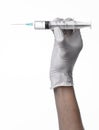 Doctor's hand holding a syringe, white-gloved hand, a large syringe, medical issue, the doctor makes an injection Royalty Free Stock Photo