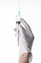 Doctor's hand holding a syringe, white-gloved hand, a large syringe, medical issue, the doctor makes an injection Royalty Free Stock Photo