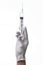 Doctor's hand holding a syringe, white-gloved hand, a large syringe, medical issue, the doctor makes an injection