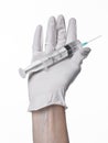 Doctor's hand holding a syringe, white-gloved hand, a large syringe, medical issue, the doctor makes an injection Royalty Free Stock Photo