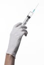 Doctor's hand holding a syringe, white-gloved hand, a large syringe, medical issue, the doctor makes an injection Royalty Free Stock Photo