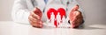 Doctor's Hand Protecting Red Heart With Family Figure Royalty Free Stock Photo