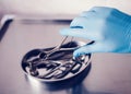 Doctor`s hand in rubber glove holding ENT tools Royalty Free Stock Photo