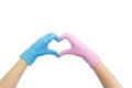 Doctor`s hands in blue and pink gloves making heart shape isolated on white. Woman`s hand gesture or sign. Virus Royalty Free Stock Photo