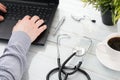 Doctor`s hands on laptop and a stethoscope Royalty Free Stock Photo