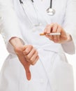 Doctor's hands showing disabling gesture and holding a cigarette Royalty Free Stock Photo