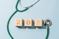 Happy new year composition. 2020 number and stethoscope over blue background.