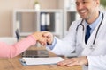 Portrait of mature doctor handshaking with patient Royalty Free Stock Photo