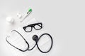 Doctor`s office desk with medical documents, charts, eyeglasses and stethoscope. Top view. Copy space Royalty Free Stock Photo