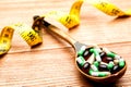 Pills in a spoon. medicines in a wooden spoon. Royalty Free Stock Photo
