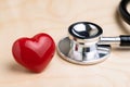 Doctor`s stethoscope with shinny red heart on wooden table, health care, medical exam or cardiology concept Royalty Free Stock Photo