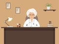 Doctor`s workplace. An elderly female doctor is sitting at the desk