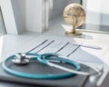 Doctor`s workspace working table with patient`s discharge blank paper form, medical prescription, stethoscope on desk