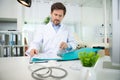 doctor sat at desk looking through folder medical notes Royalty Free Stock Photo