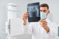 Doctor with scan result after ultrasound diagnostic of pelvis. Royalty Free Stock Photo