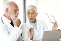 doctor senior man medical woman hospital conversation healthcare medicine team teamwork talking laptop Royalty Free Stock Photo