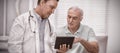 Doctor and senior patient using digital tablet Royalty Free Stock Photo
