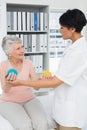 Doctor with senior patient using stress buster balls Royalty Free Stock Photo