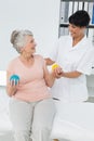 Doctor with senior patient using stress buster balls Royalty Free Stock Photo