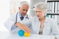 Doctor with senior patient using stress buster balls Royalty Free Stock Photo