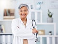 Doctor, senior woman and stethoscope, arms crossed for healthcare in hospital and professional cardiovascular surgeon Royalty Free Stock Photo