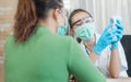 Doctor and senior woman wearing facemasks during coronavirus and flu outbreak. Virus and illness protection, home quarantine.