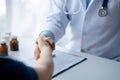 The doctor shakes hands with the patient after the examination and consultation is complete, the concept of treatment and