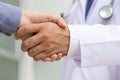 Doctor shakes hands with a patient