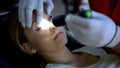 Doctor shining light into patient eye, testing pupil reflexes, first aid closeup Royalty Free Stock Photo