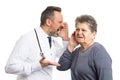 Doctor shouting in deaf patient ear Royalty Free Stock Photo