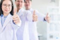 doctor show OK or confirm sign with thumb up. scientist standing and smiling ,strong tough medical team Royalty Free Stock Photo