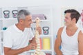 Doctor showing anatomical spine to his patient Royalty Free Stock Photo