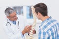 Doctor showing anatomical spine to his patient Royalty Free Stock Photo