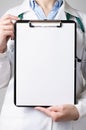 Doctor showing blank clipboard Royalty Free Stock Photo