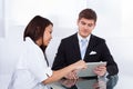 Doctor showing digital tablet to businessman