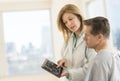 Doctor Showing Digital Tablet To Patient In Clinic Royalty Free Stock Photo