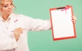 Doctor showing folder with pink ribbon by pen. Royalty Free Stock Photo