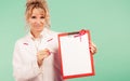 Doctor showing folder with pink ribbon by pen. Royalty Free Stock Photo